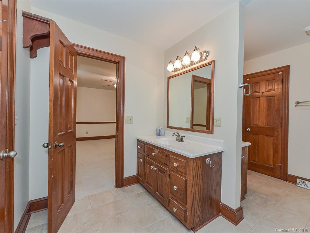 402 3 Knotts Road Monroe, NC 28112 - Photo 32 of 48 a bathroom with a double vanity sink mirror and shower