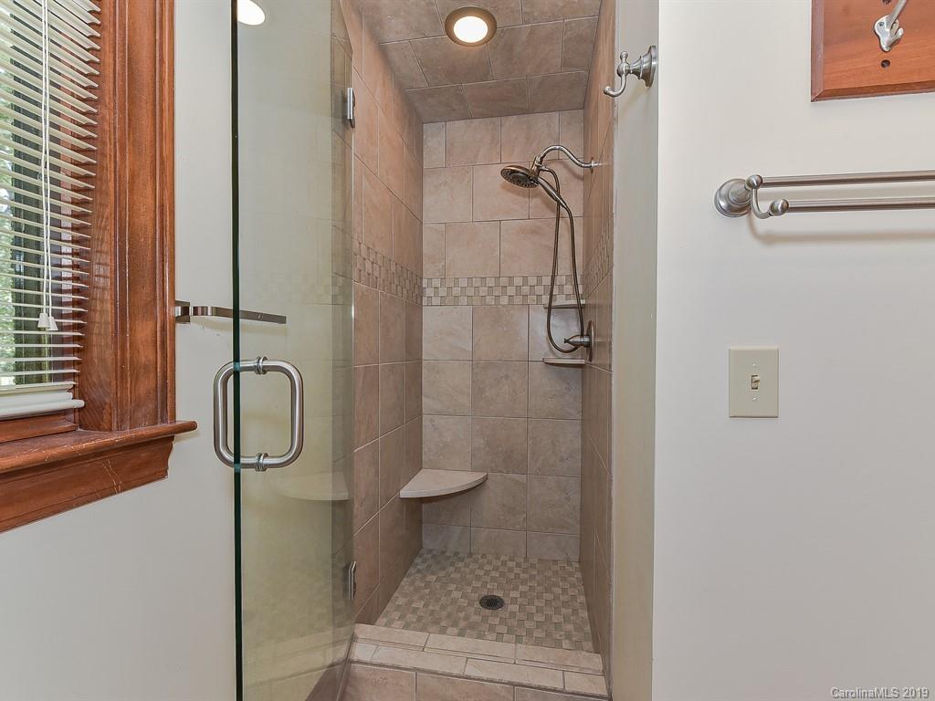 402 3 Knotts Road Monroe, NC 28112 - Photo 33 of 48 a bathroom with a glass shower door