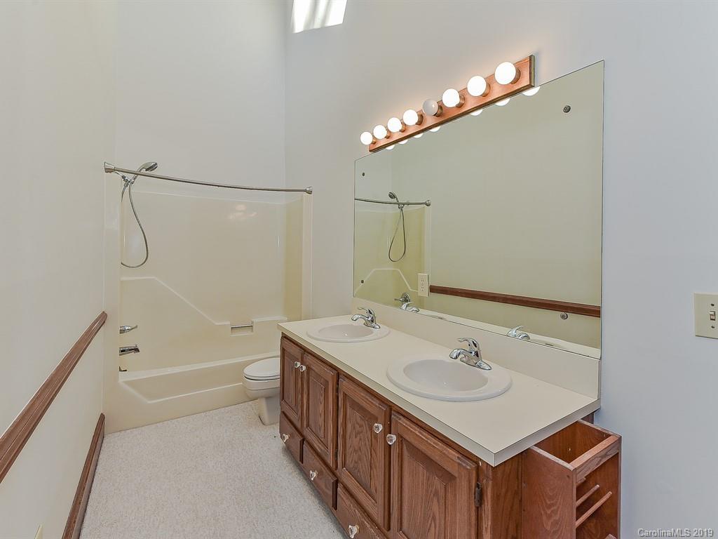 402 3 Knotts Road Monroe, NC 28112 - Photo 37 of 48 a bathroom with a sink a mirror and a bathtub
