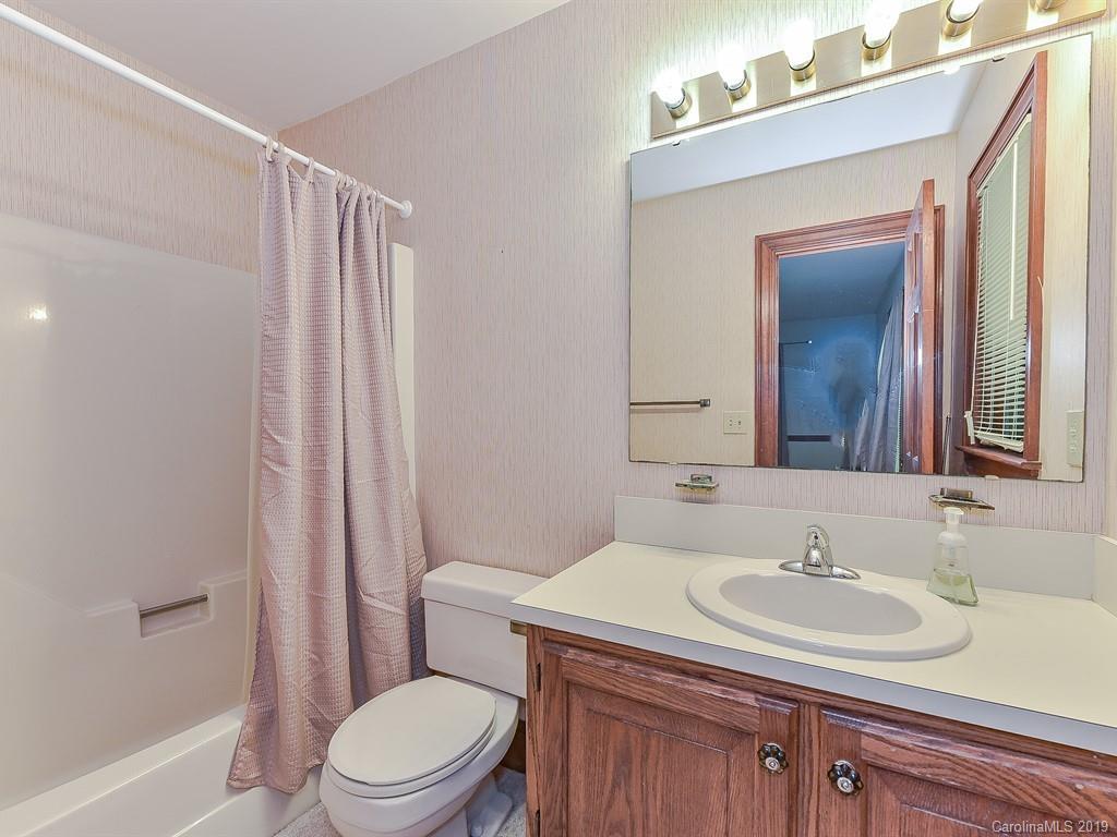 402 3 Knotts Road Monroe, NC 28112 - Photo 42 of 48 a bathroom with a sink toilet vanity and shower