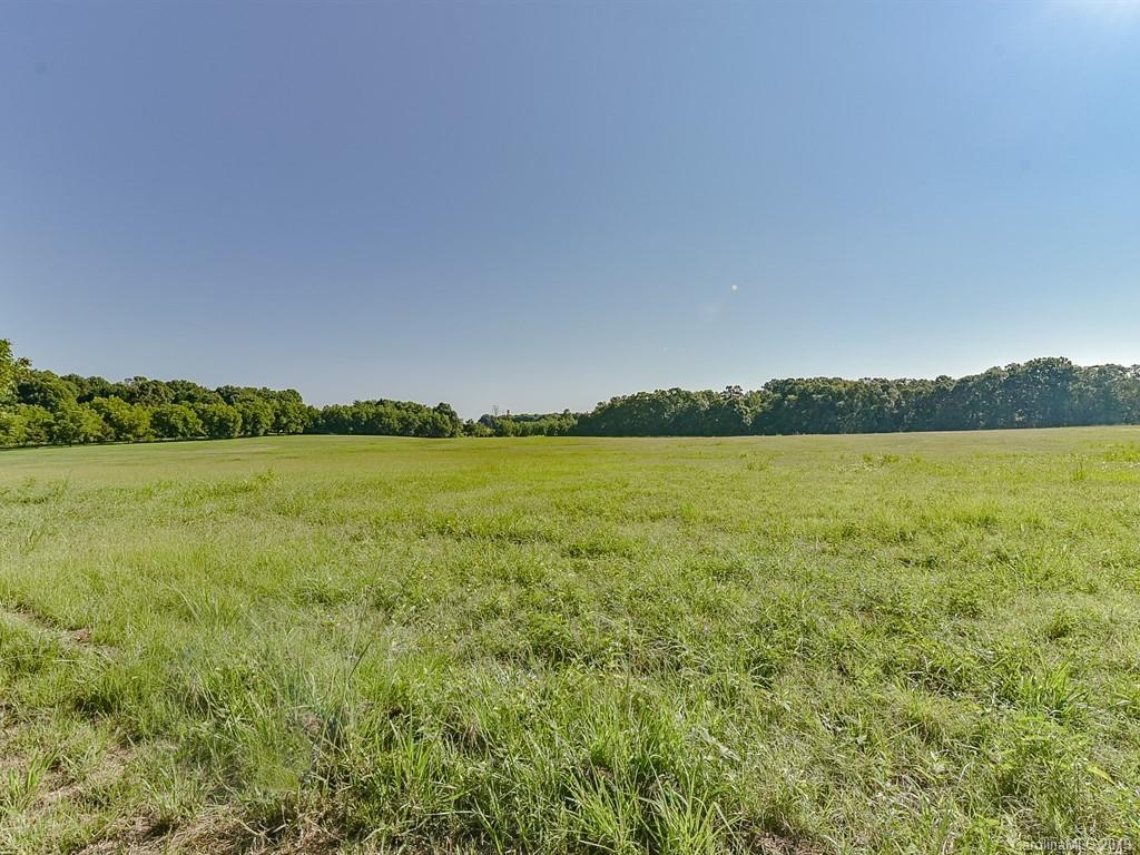 402 3 Knotts Road Monroe, NC 28112 - Photo 43 of 48 a view of a lake with houses in the back