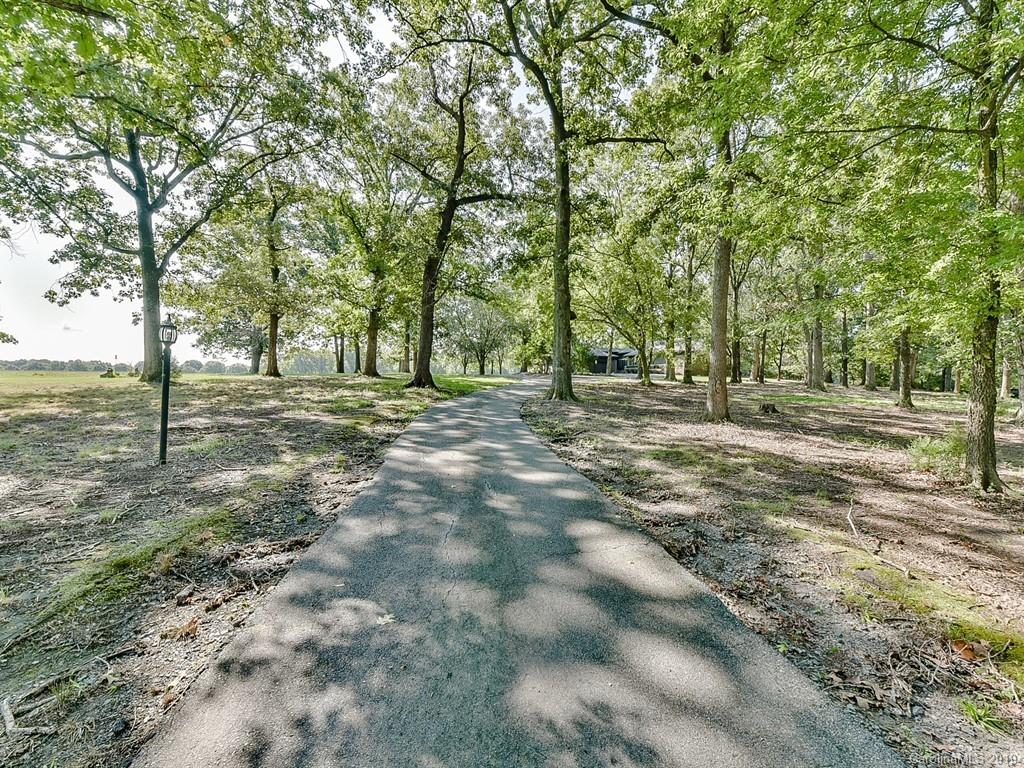 402 3 Knotts Road Monroe, NC 28112 - Photo 47 of 48 a view of a field with trees in the background