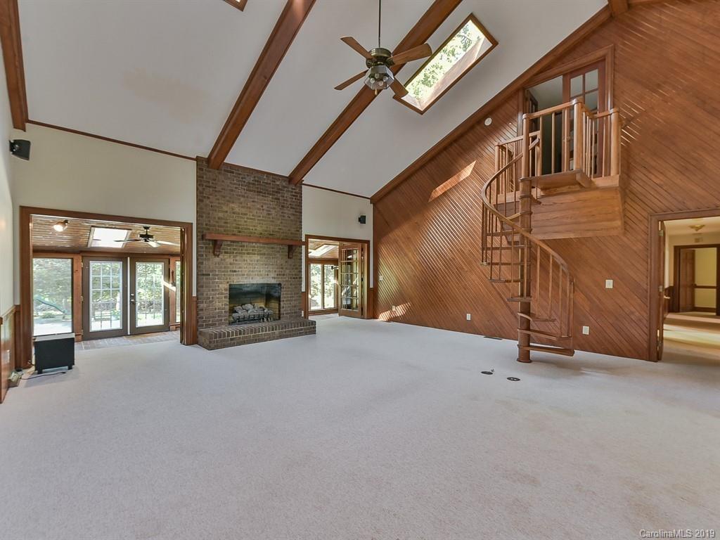 402 3 Knotts Road Monroe, NC 28112 - Photo 7 of 48 an empty room with fireplace and windows