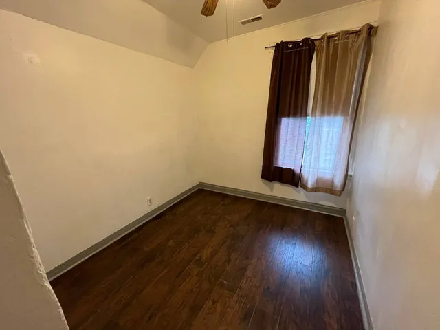 a view of a room with wooden floor