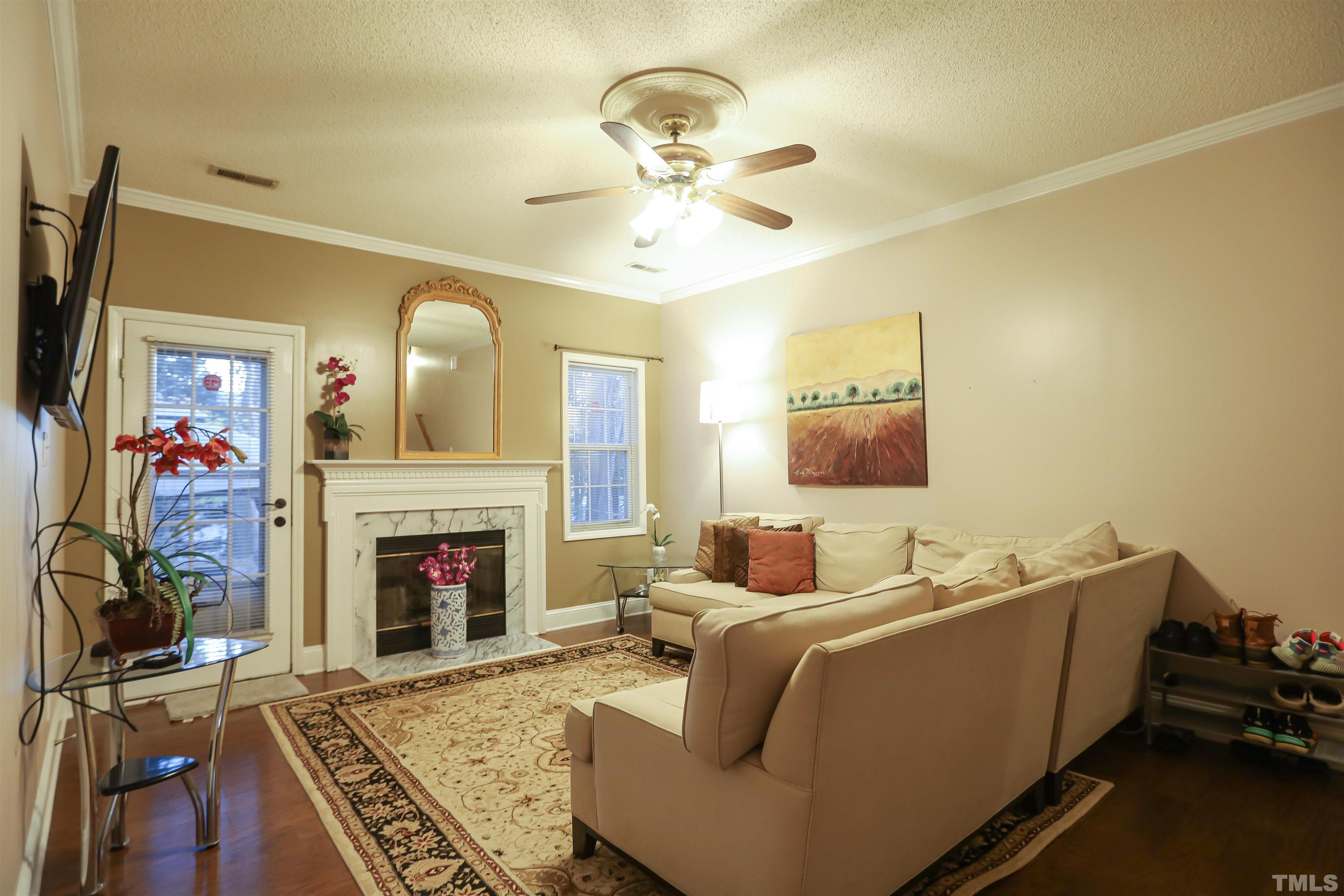 4102 Beaufain Street Raleigh, NC 27604 - Photo 11 of 28 a living room with furniture and a fireplace