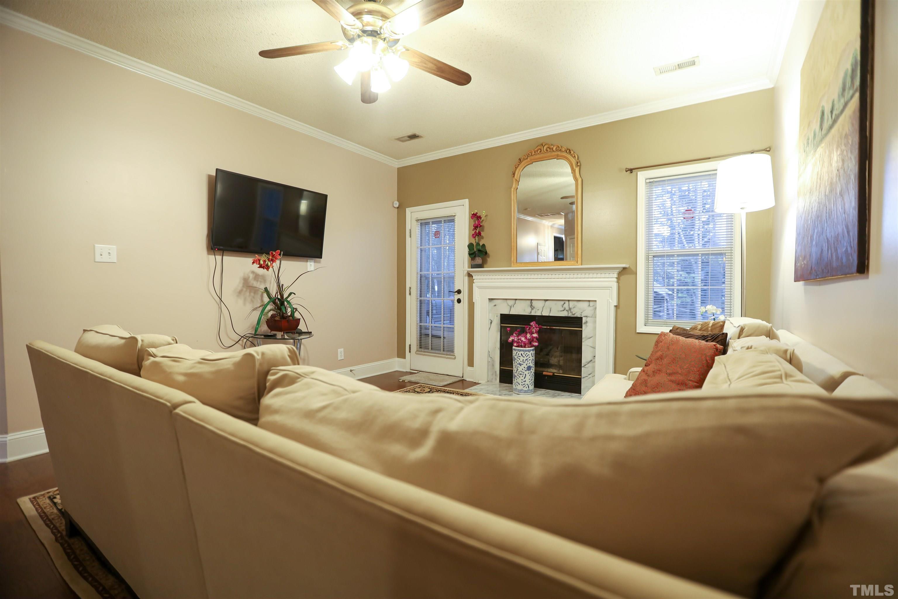 4102 Beaufain Street Raleigh, NC 27604 - Photo 12 of 28 a living room with furniture and a fireplace