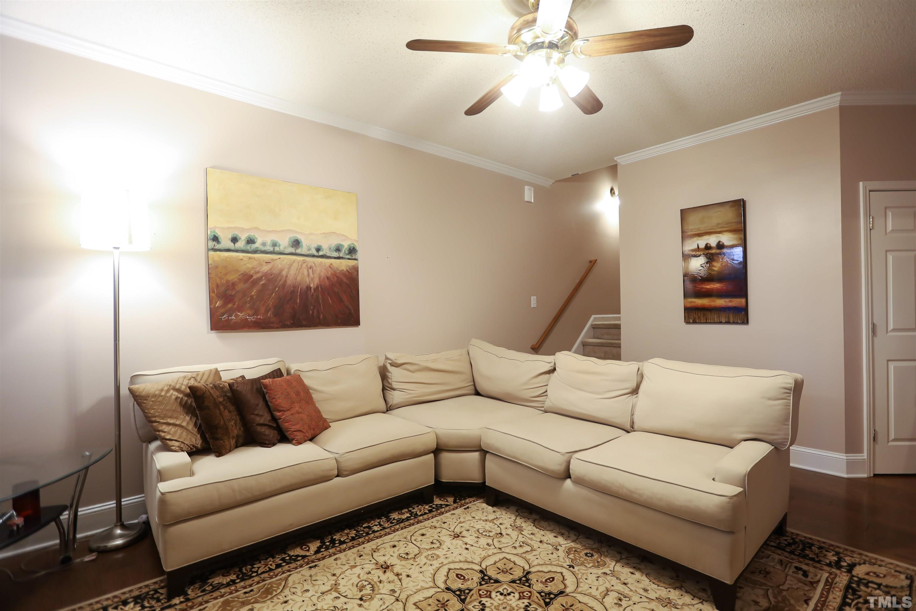 4102 Beaufain Street Raleigh, NC 27604 - Photo 18 of 28 a living room with furniture and a lamp
