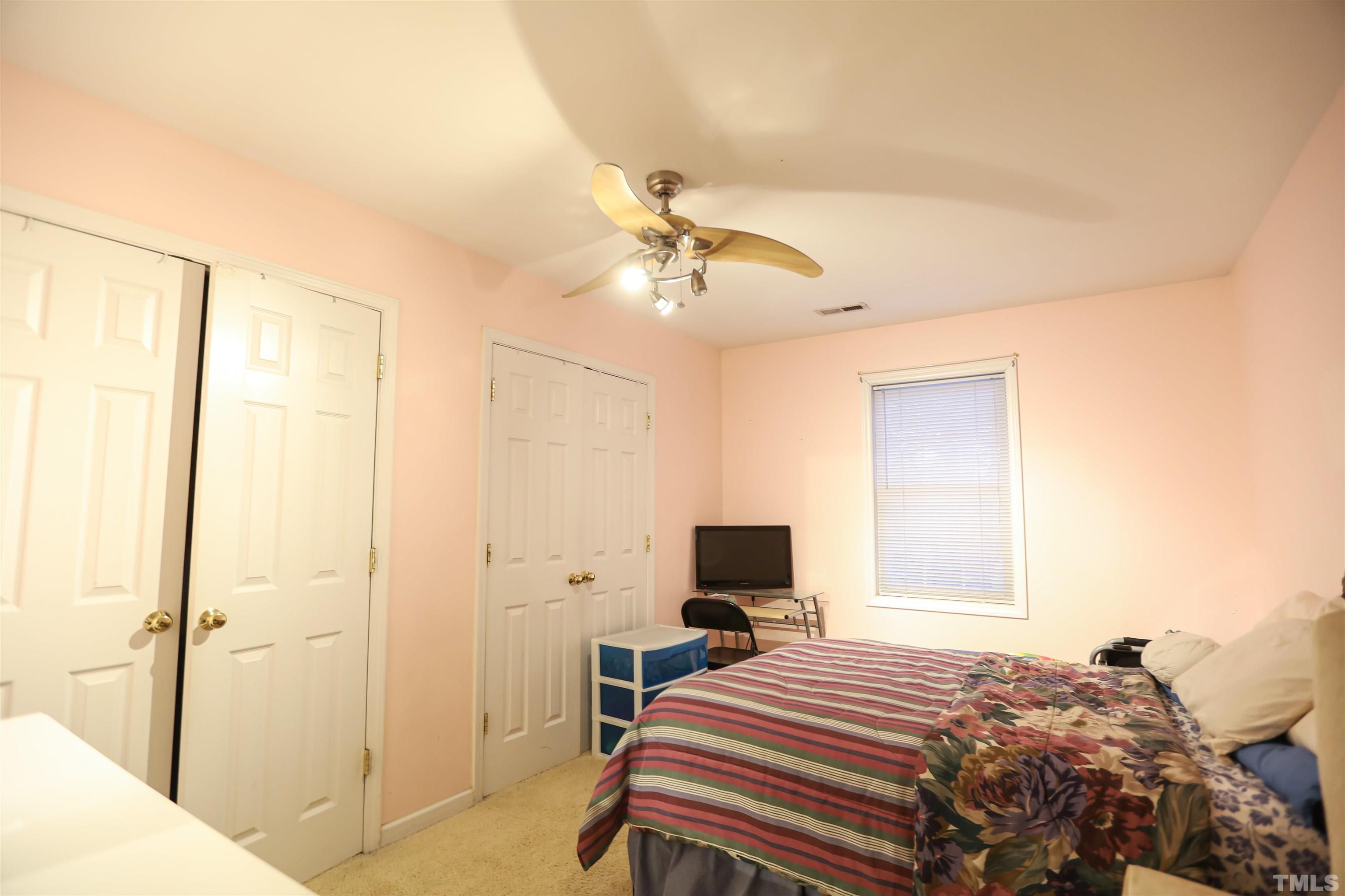 4102 Beaufain Street Raleigh, NC 27604 - Photo 21 of 28 a bedroom with a bed and a chandelier