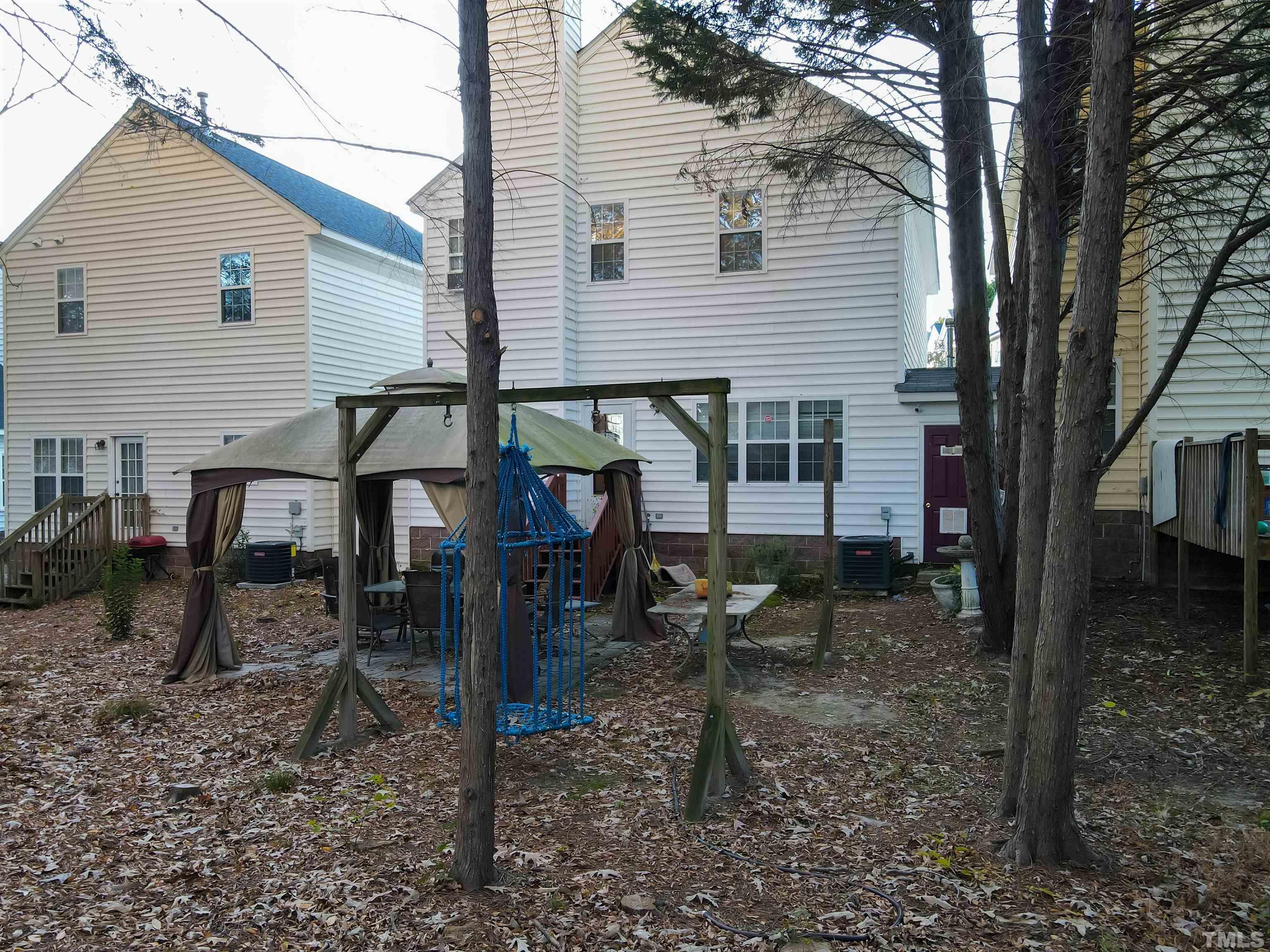 4102 Beaufain Street Raleigh, NC 27604 - Photo 27 of 28 a backyard of a house with barbeque oven table and chairs