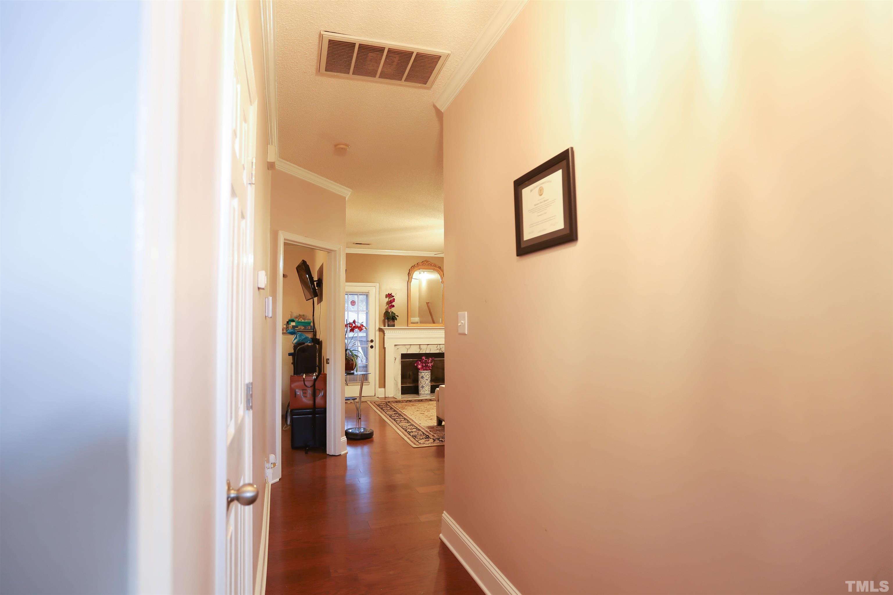4102 Beaufain Street Raleigh, NC 27604 - Photo 10 of 28 a view of a hallway with wooden floor