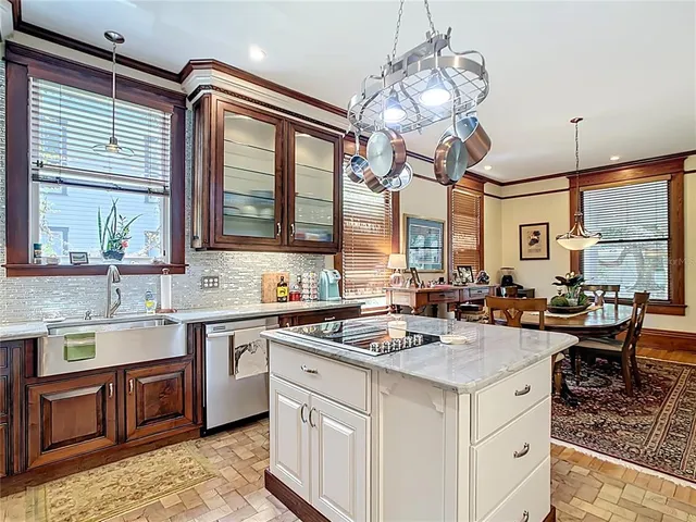 a kitchen with stainless steel appliances granite countertop a sink stove and cabinets