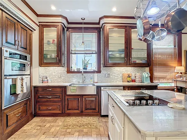a kitchen with a stove a sink and a refrigerator