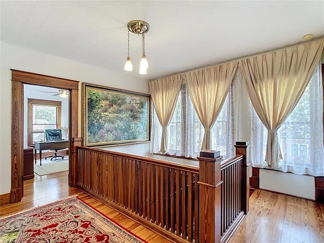 a view of a hallway with furniture and staircase