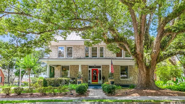 front view of a house with a tree