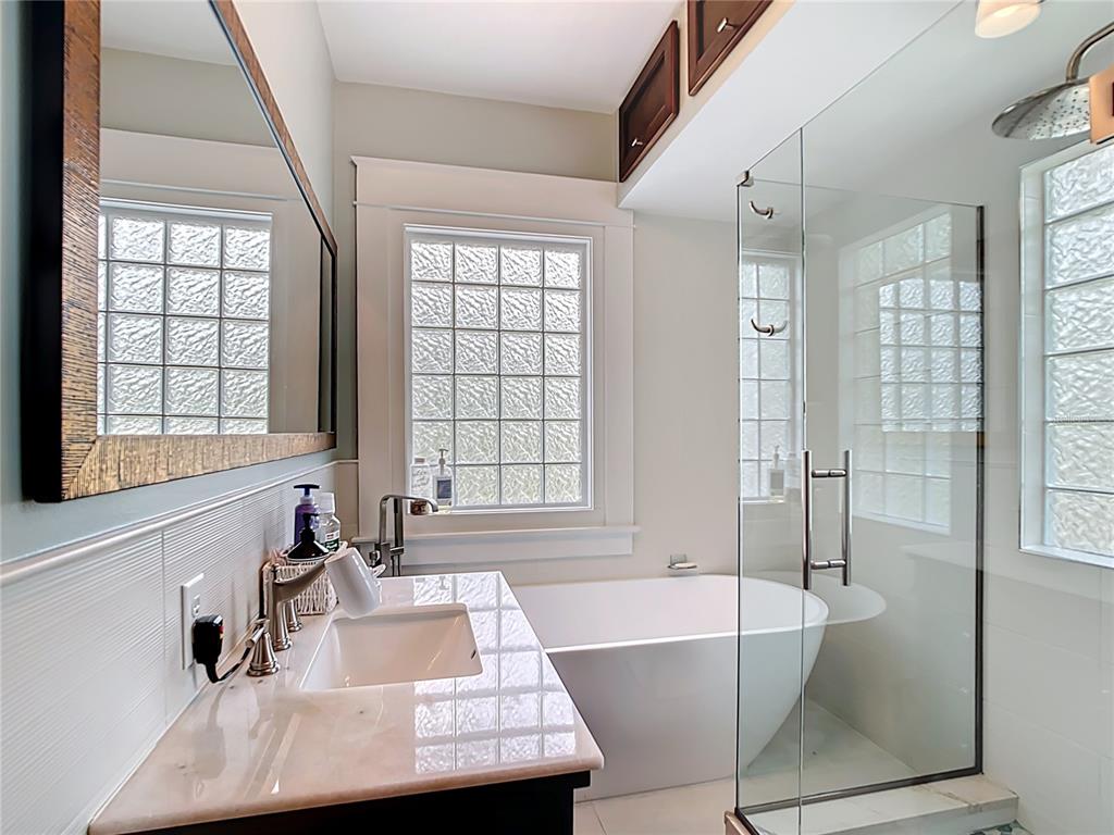 705 Southeast 5th Street Ocala, FL 34471 - Photo 22 of 41 a bathroom with a tub a sink and a window