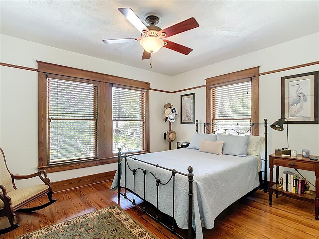 705 Southeast 5th Street Ocala, FL 34471 - Photo 24 of 41 a bedroom with a bed a table and a chandelier