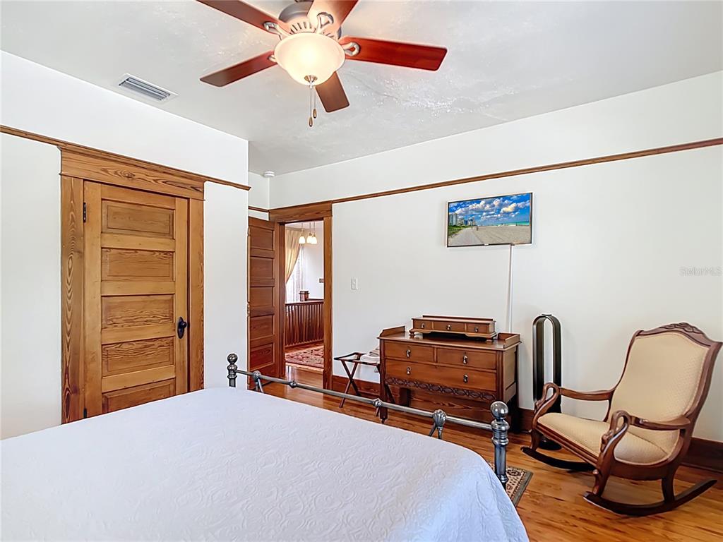 705 Southeast 5th Street Ocala, FL 34471 - Photo 25 of 41 a bedroom with a bed and a chair