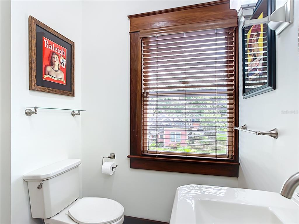 705 Southeast 5th Street Ocala, FL 34471 - Photo 29 of 41 a bathroom with a toilet sink and a window