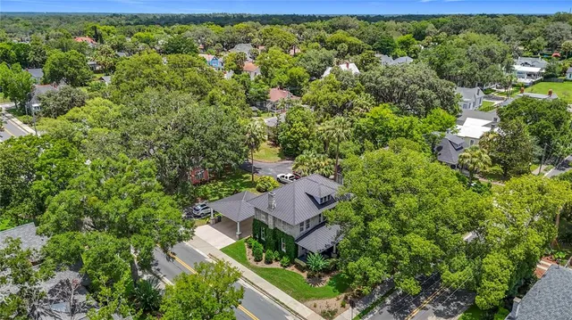 an aerial view of a house with yard