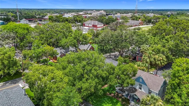 an aerial view of a house with a yard