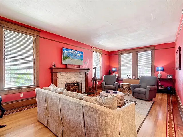 a living room with furniture a fireplace and a flat screen tv