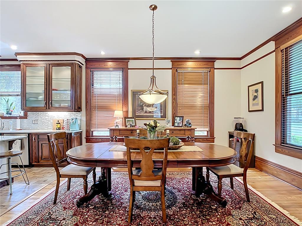 705 Southeast 5th Street Ocala, FL 34471 - Photo 10 of 41 a dining room with furniture a chandelier and wooden floor