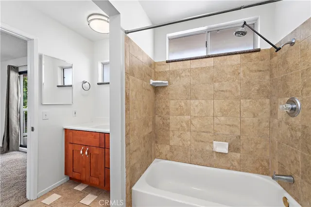 a bathroom with a tub a sink and shower