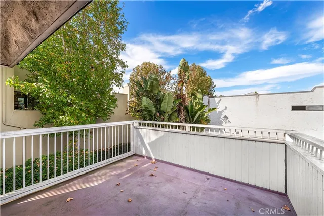 a view of a balcony with wooden fence and floor