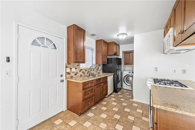 a kitchen with stainless steel appliances granite countertop a stove and a refrigerator