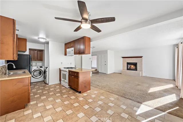 a view of a kitchen with a stove cabinets and a ceiling fan