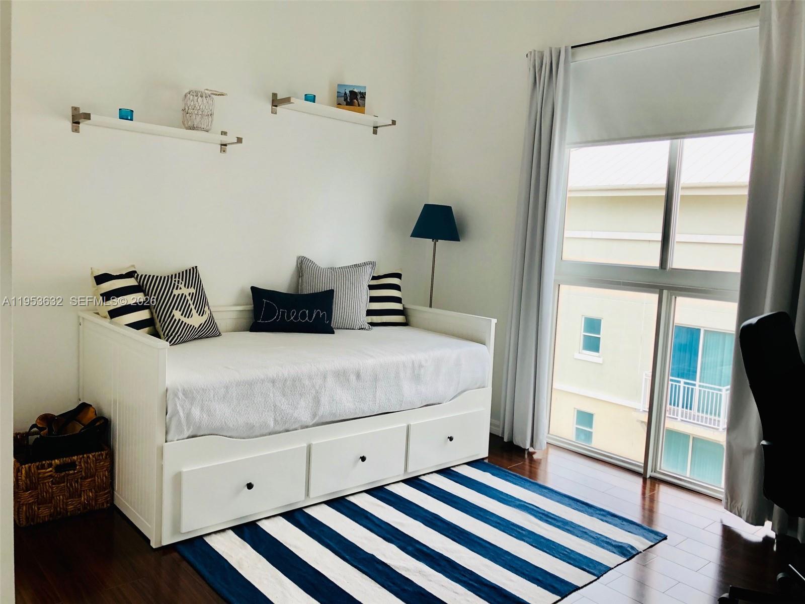 7290 Southwest 90th Street, Unit 701 Miami, FL 33156 - Photo 12 of 16 a bedroom with a bed and a window