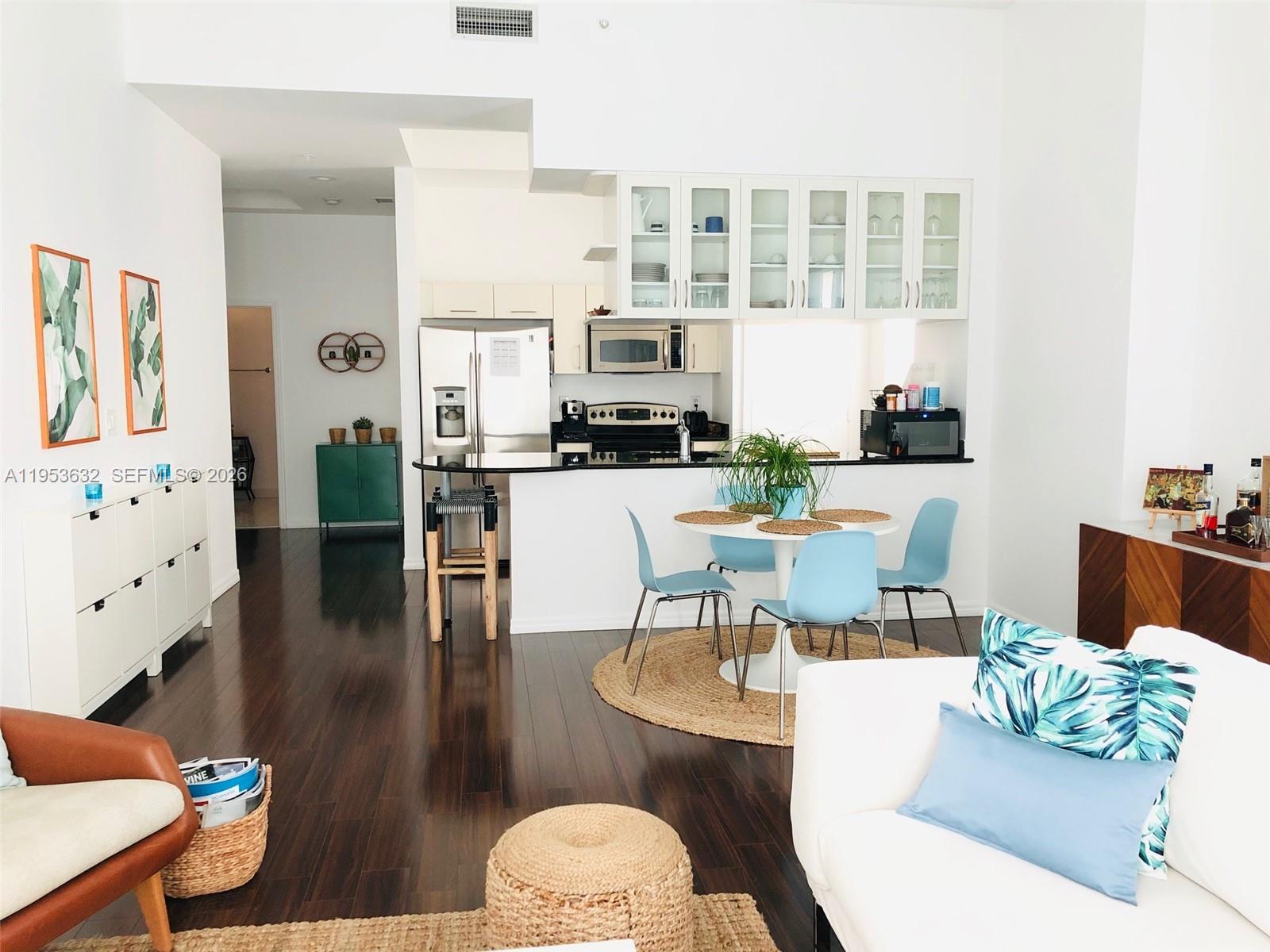 7290 Southwest 90th Street, Unit 701 Miami, FL 33156 - Photo 5 of 16 a living room with furniture and wooden floor
