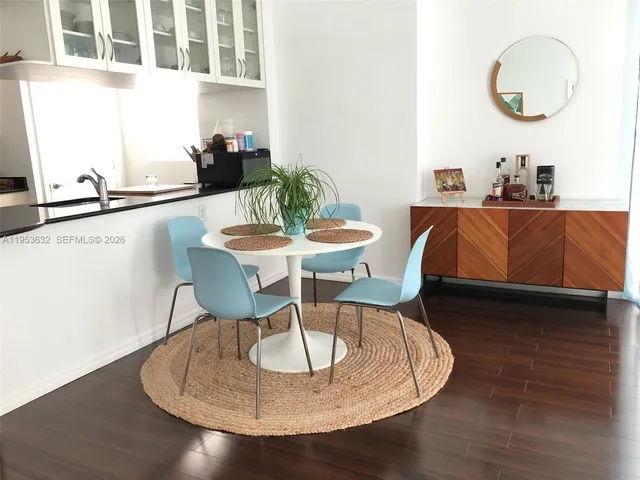 a dining room with furniture and wooden floor