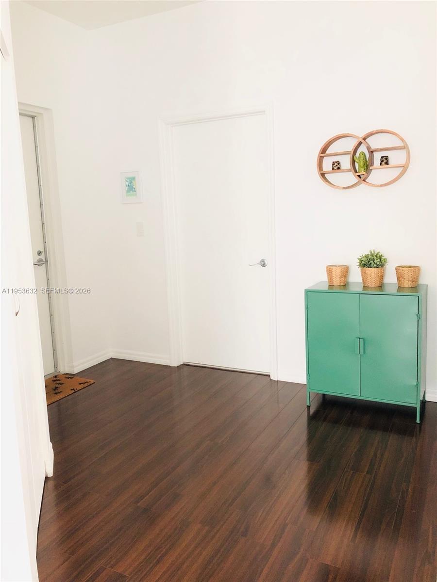 7290 Southwest 90th Street, Unit 701 Miami, FL 33156 - Photo 9 of 16 a view of a room with wooden floor