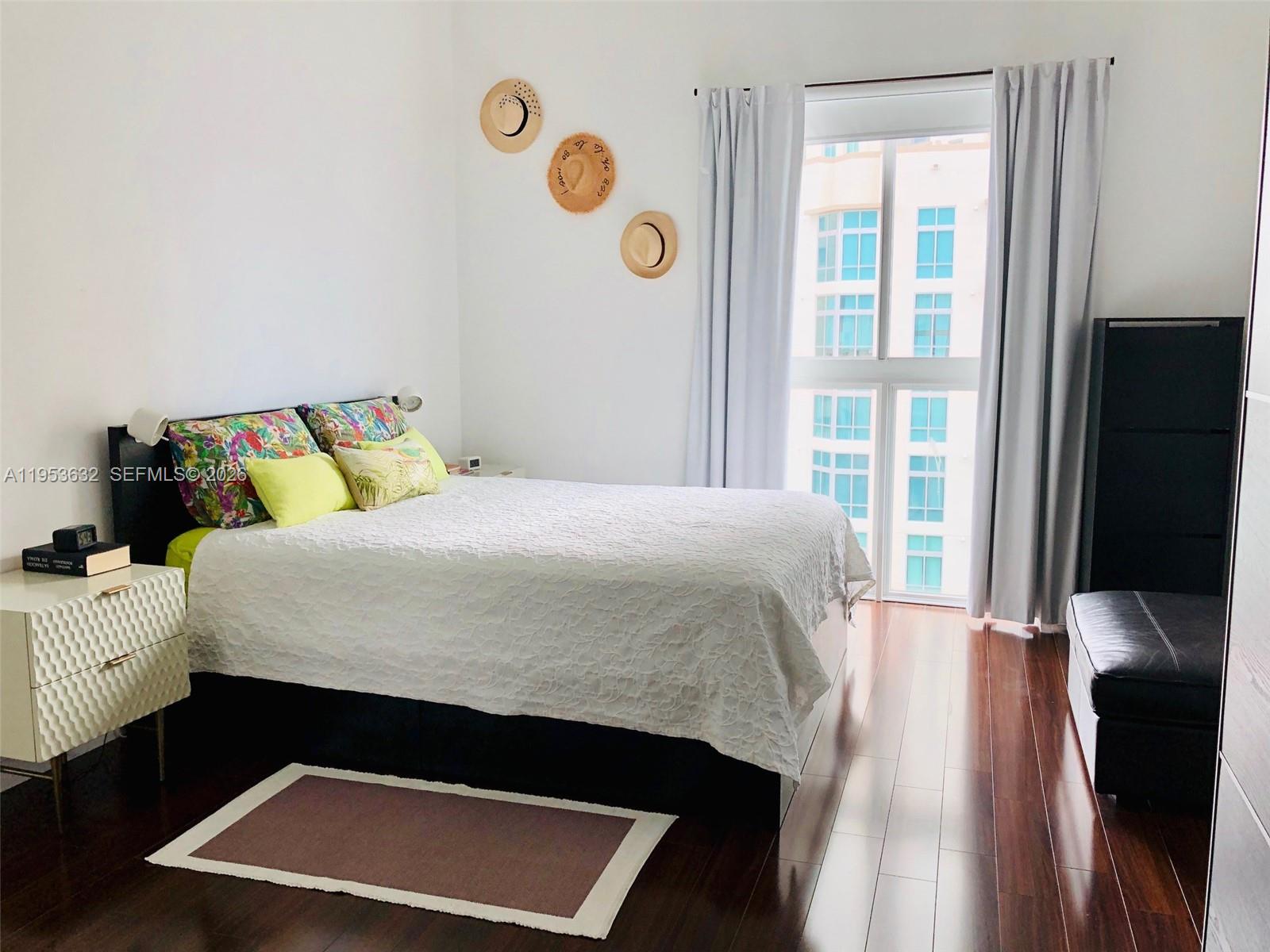 7290 Southwest 90th Street, Unit 701 Miami, FL 33156 - Photo 10 of 16 a bedroom with a bed and a window