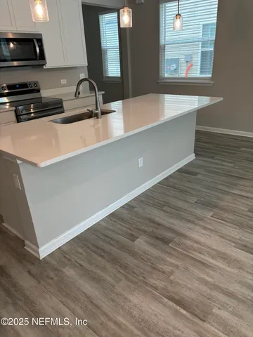 a kitchen with a sink and a stove top oven