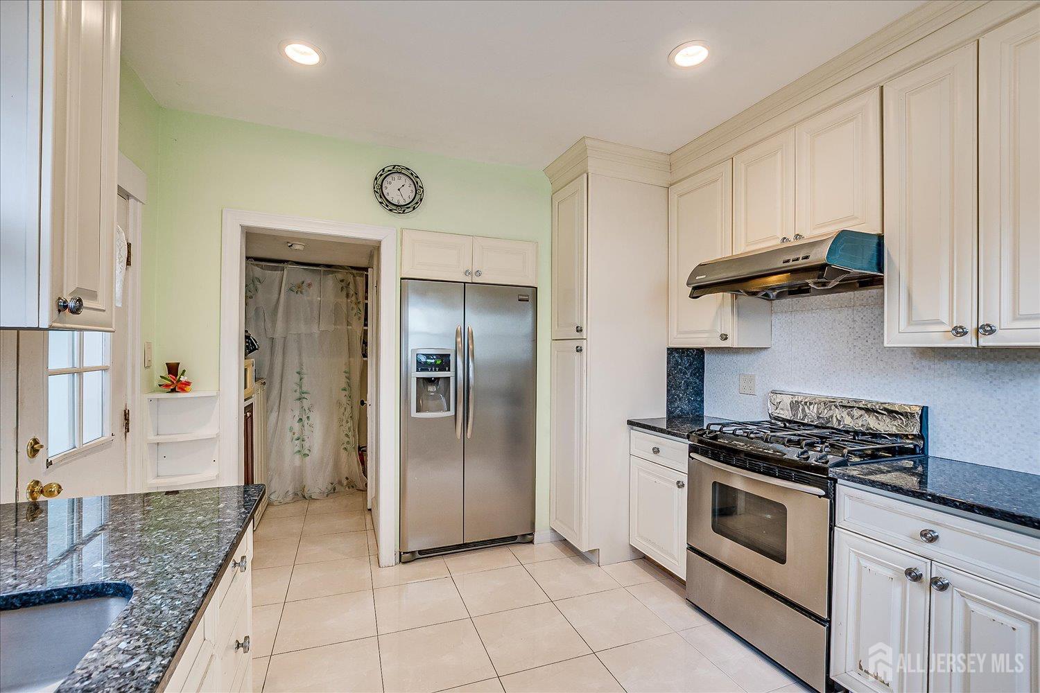 311 Prospect Avenue Dunellen, NJ 08812 - Photo 13 of 42 a kitchen with stainless steel appliances granite countertop a refrigerator and a stove
