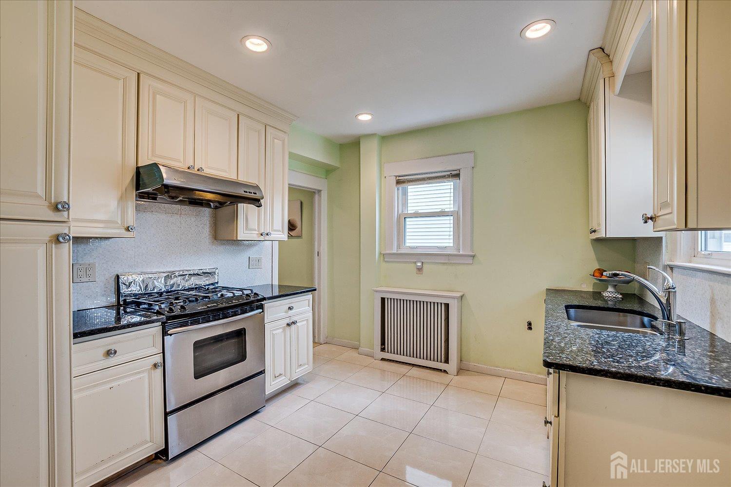 311 Prospect Avenue Dunellen, NJ 08812 - Photo 14 of 42 a kitchen with stainless steel appliances granite countertop a stove a sink and a microwave