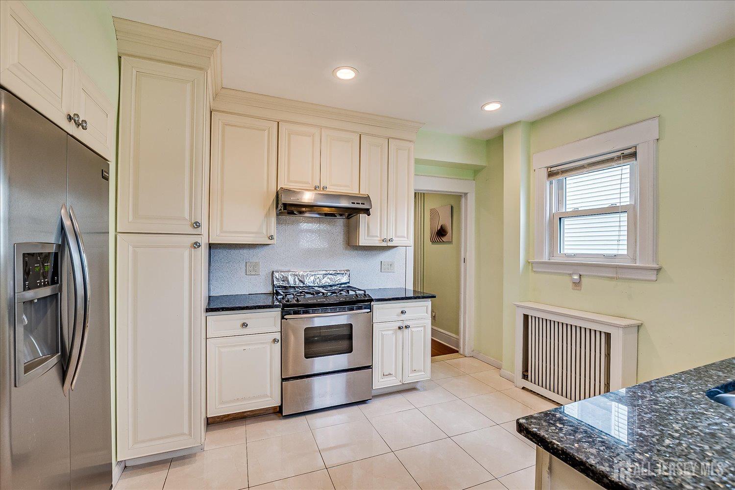 311 Prospect Avenue Dunellen, NJ 08812 - Photo 16 of 42 a kitchen with stainless steel appliances granite countertop a stove a refrigerator and a sink