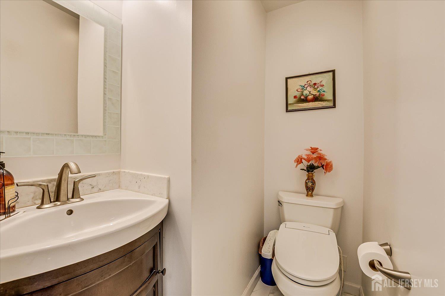 311 Prospect Avenue Dunellen, NJ 08812 - Photo 17 of 42 a bathroom with a toilet sink and mirror