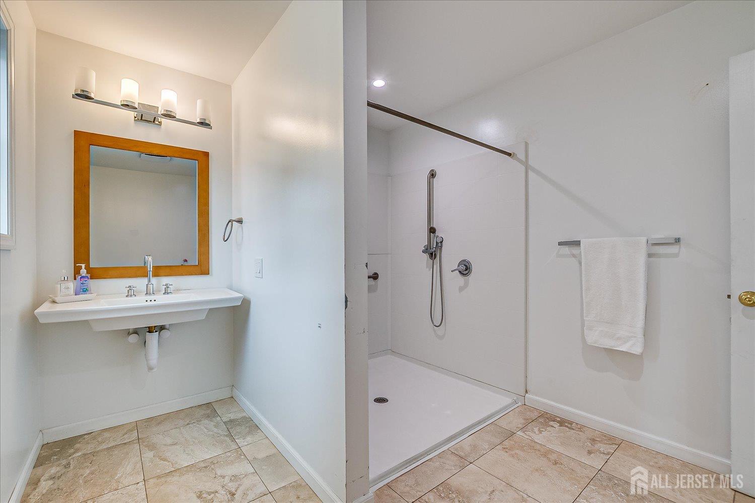 311 Prospect Avenue Dunellen, NJ 08812 - Photo 22 of 42 a bathroom with a sink mirror and a bathtub