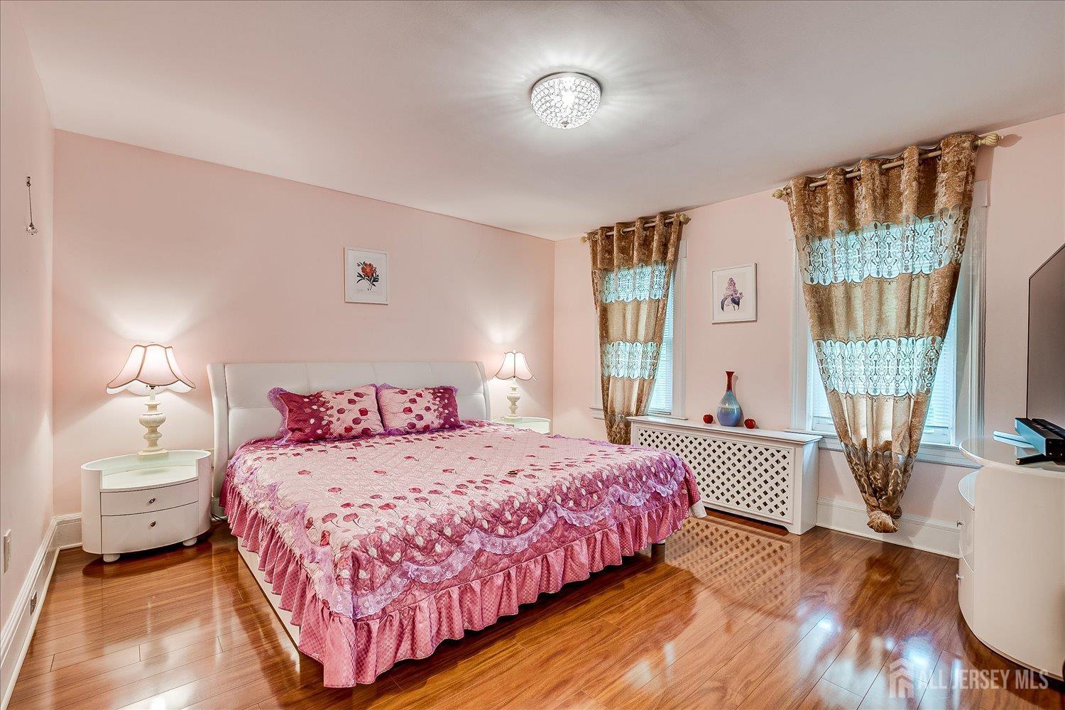 311 Prospect Avenue Dunellen, NJ 08812 - Photo 28 of 42 a bedroom with a bed and wooden floor