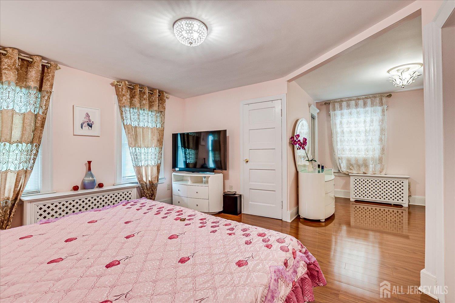 311 Prospect Avenue Dunellen, NJ 08812 - Photo 29 of 42 a bedroom with a bed and a flat screen tv