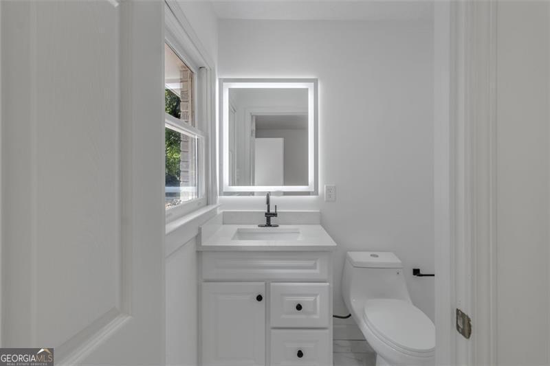722 Northern Clarkston, GA 30021 - Photo 15 of 31 a bathroom with a toilet sink and mirror