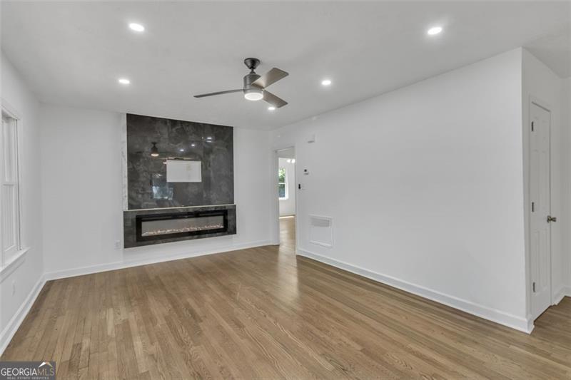 722 Northern Clarkston, GA 30021 - Photo 4 of 31 an empty room with wooden floor cabinet and windows