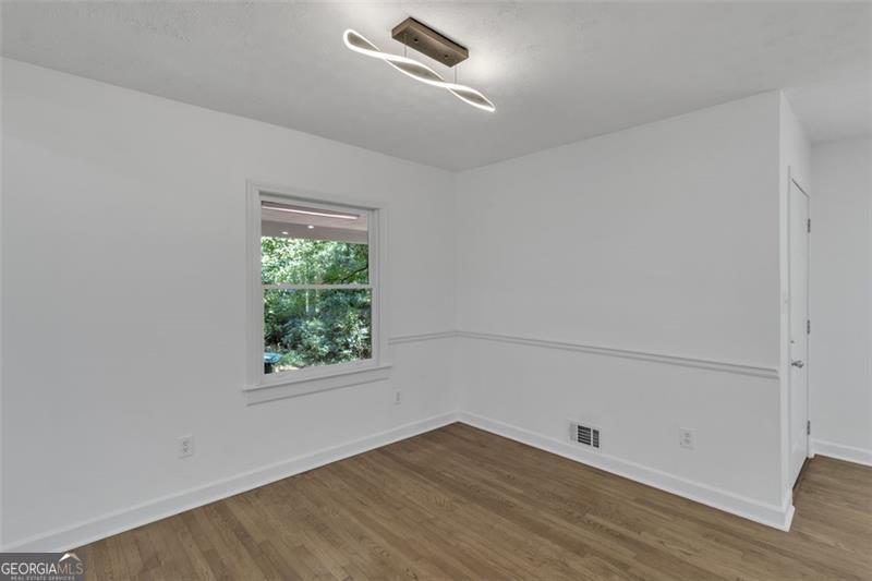 722 Northern Clarkston, GA 30021 - Photo 8 of 31 an empty room with wooden floor and windows