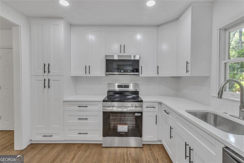 722 Northern Clarkston, GA 30021 - Photo 10 of 31 a kitchen with white cabinets and appliances
