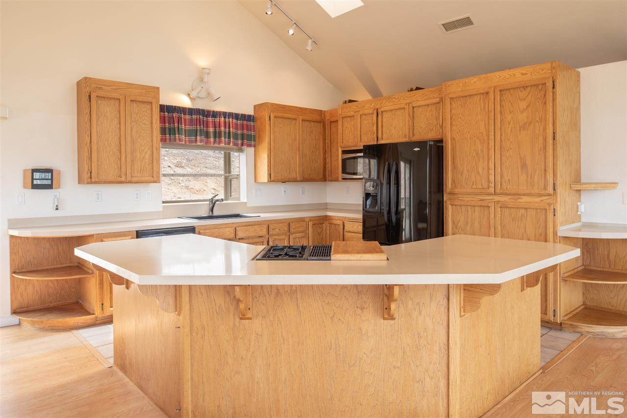 15505 Minnetonka Circle Reno, NV 89521 - Photo 7 of 25 a kitchen with stainless steel appliances granite countertop a sink a stove and a refrigerator