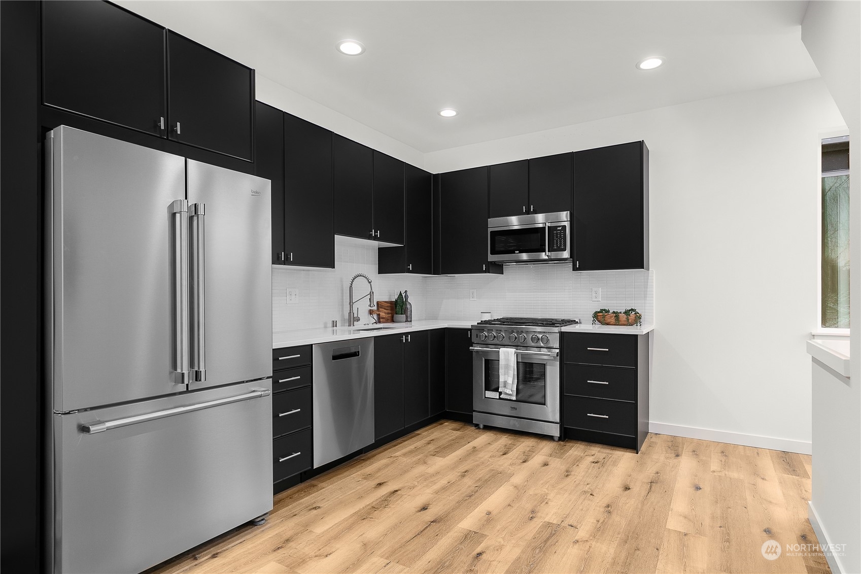 9429 18th Avenue Southwest, Unit B Seattle, WA 98106 - Photo 11 of 28 a kitchen with a refrigerator and a stove top oven