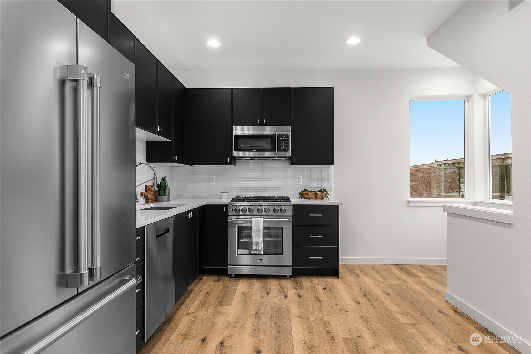 9429 18th Avenue Southwest, Unit B Seattle, WA 98106 - Photo 12 of 28 a kitchen with stainless steel appliances a stove a sink and a refrigerator